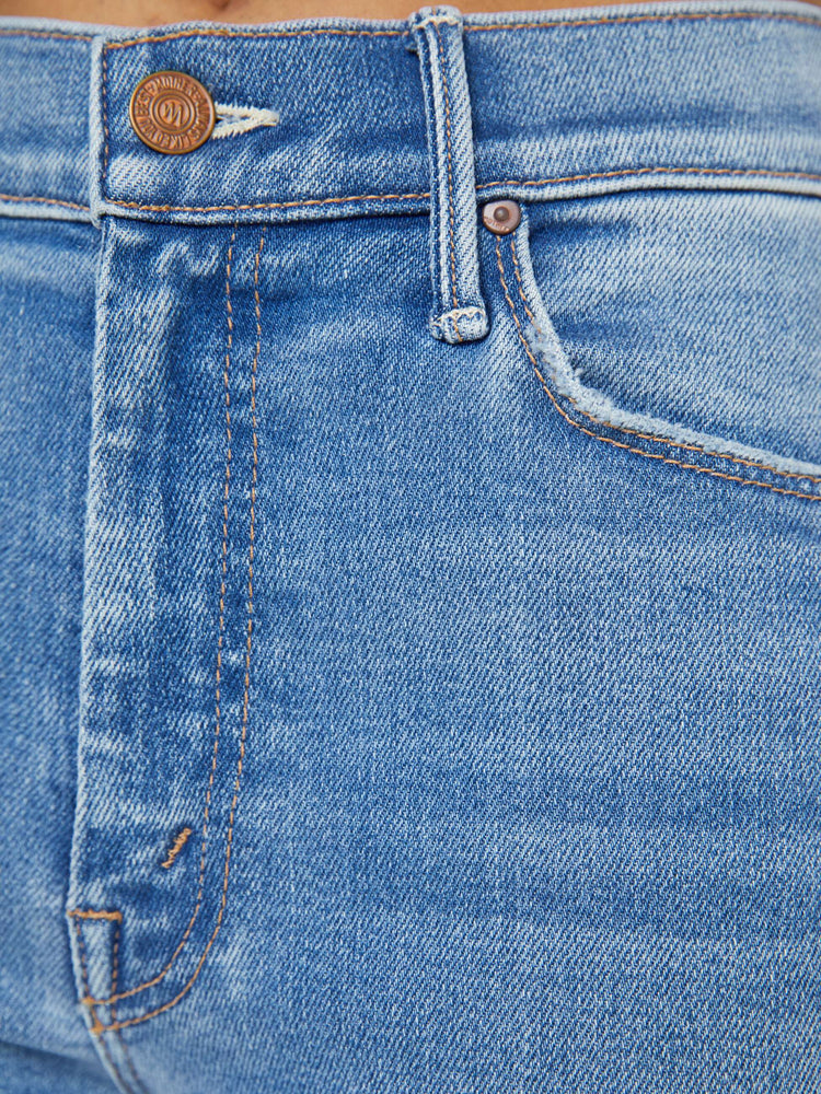 Swatch view of a petite woman flare jean has a mid rise with a sneaker-length inseam and a clean hem in mid-blue wash.