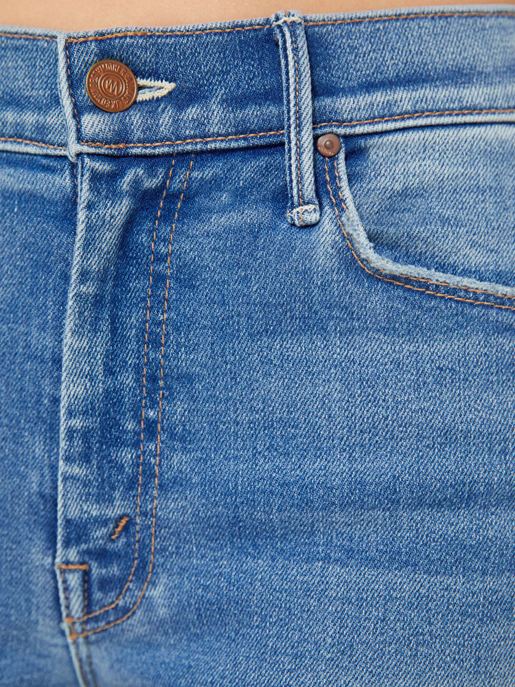 Swatch view of a petite woman flare jean has a mid rise with a sneaker-length inseam and a clean hem in mid-blue wash.