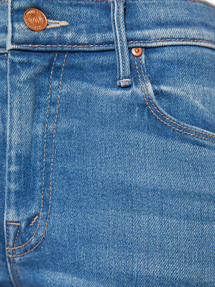 Swatch view of a petite woman in a mid blue mid rise with a 28-inch inseam and a clean hem.