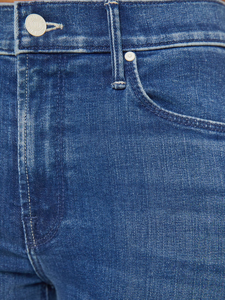 Swatch view of a petite woman mid-rise straight leg jean its at the ankle with a clean hem in a mid blue wash.