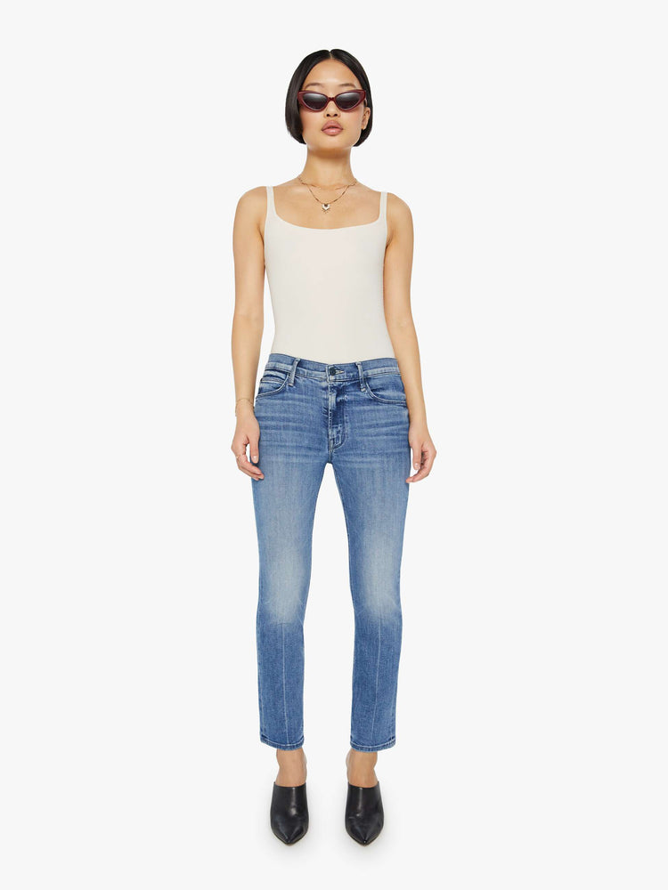 Front view of a womens medium blue wash jean featuring a mid rise and straight leg with an ankle length clean hem.