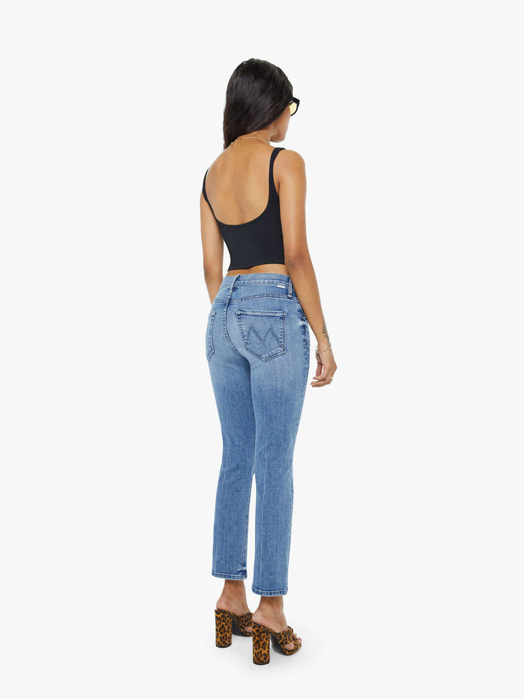 Back view of a petites womens medium blue wash jean featuring a mid rise and straight leg with an ankle length clean hem.