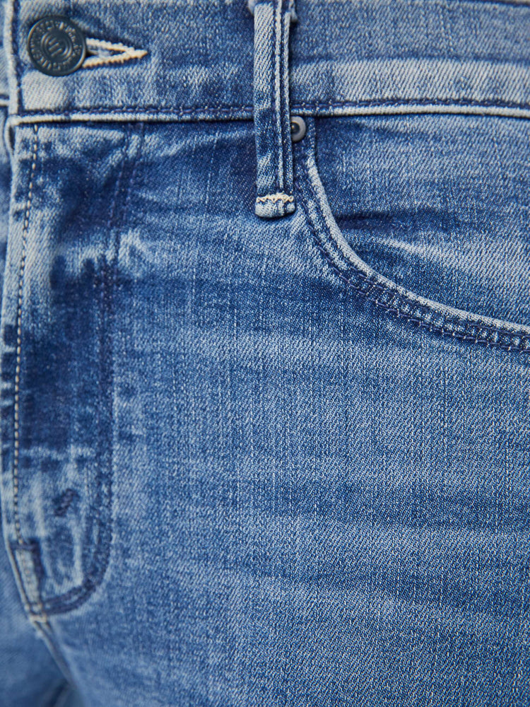 Close up detail view of a medium blue wash jean.