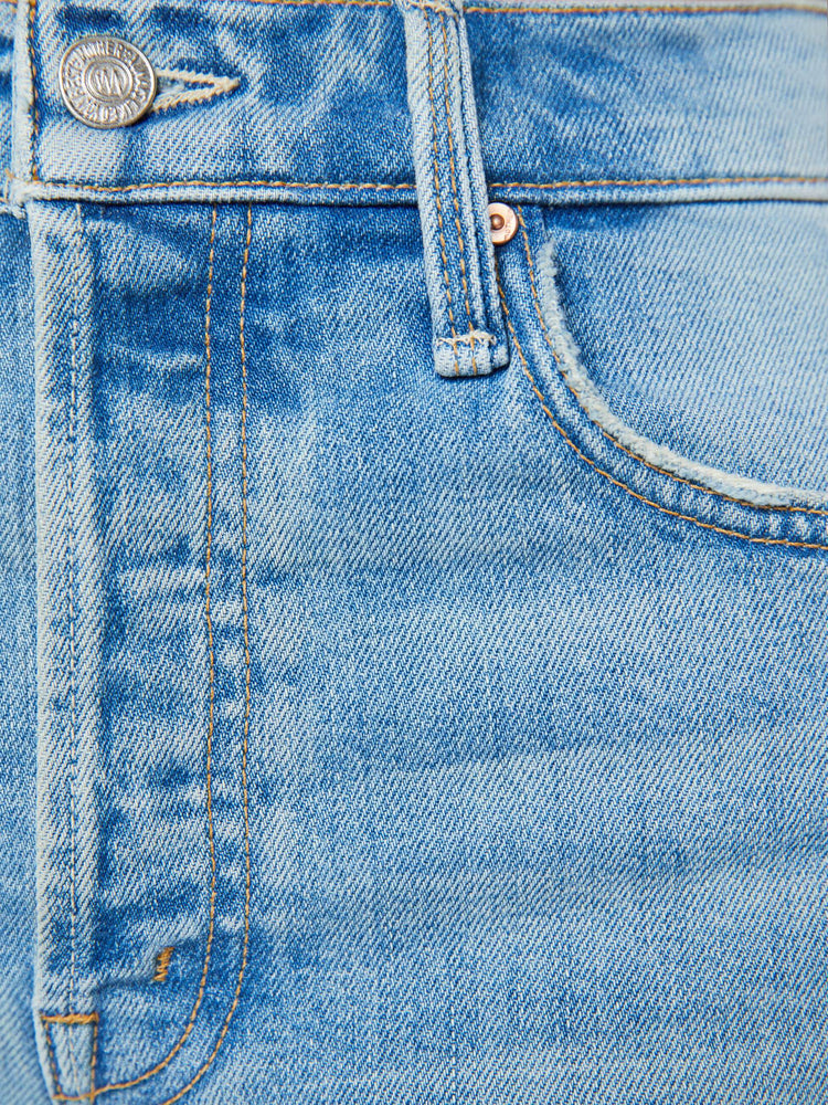 Swatch view of a woman in a light blue high-waisted wide-leg jeans with a button fly, 29-inch inseam and clean hem.