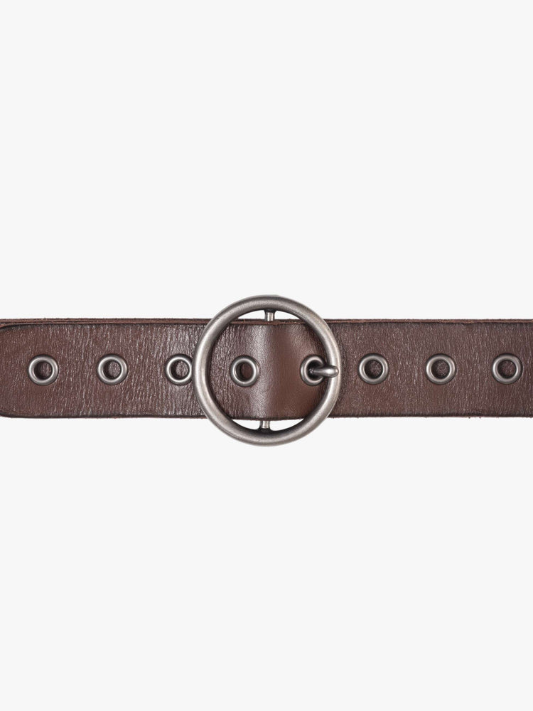 Close up  view of a dark brown vintage-inspired belt with an oversized circular buckle and round rivets throughout.