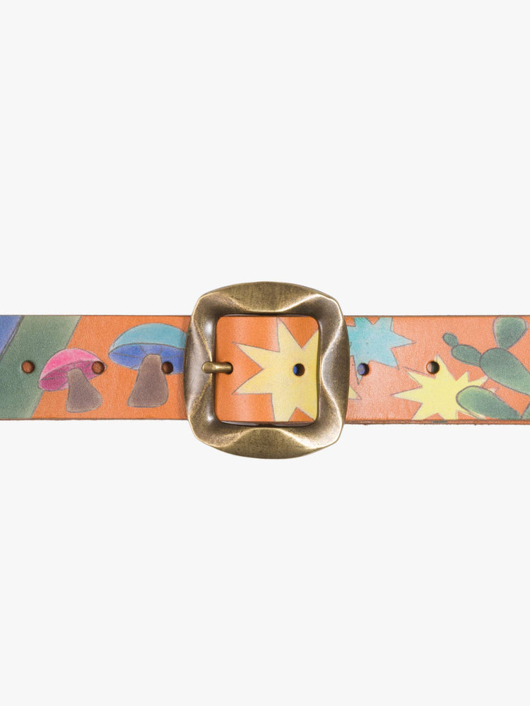 Buckle flat wide belt made from 100% leather in tan with hand-painted stars, mushrooms and rainbow stripes, and an oversized brass buckle.