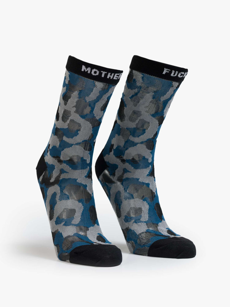 Flats view of classic tube socks with an explicit message from MOTHER. The socks are designed in a translucent blue, grey and tan oversized leopard print with black trim and text in white.