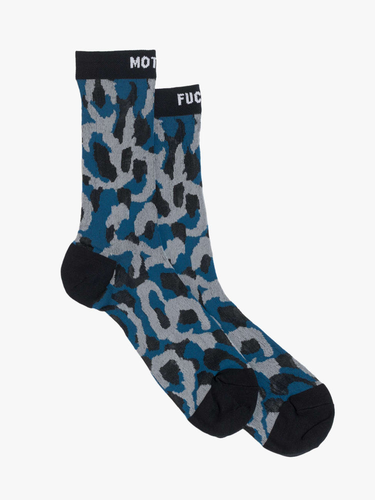 Side view of classic tube socks with an explicit message from MOTHER. The socks are designed in a translucent blue, grey and tan oversized leopard print with black trim and text in white.