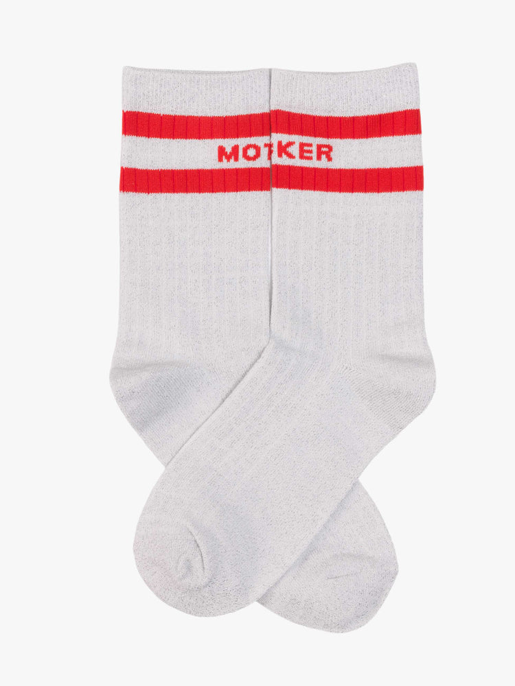Flatview of silver glitter with red stripes and text across the top.
