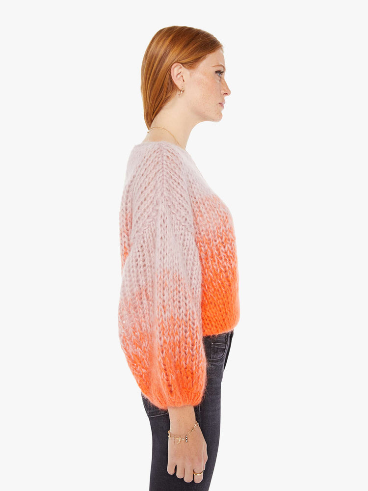 Side  view women's long sleeve sweater in colors orange and pink.