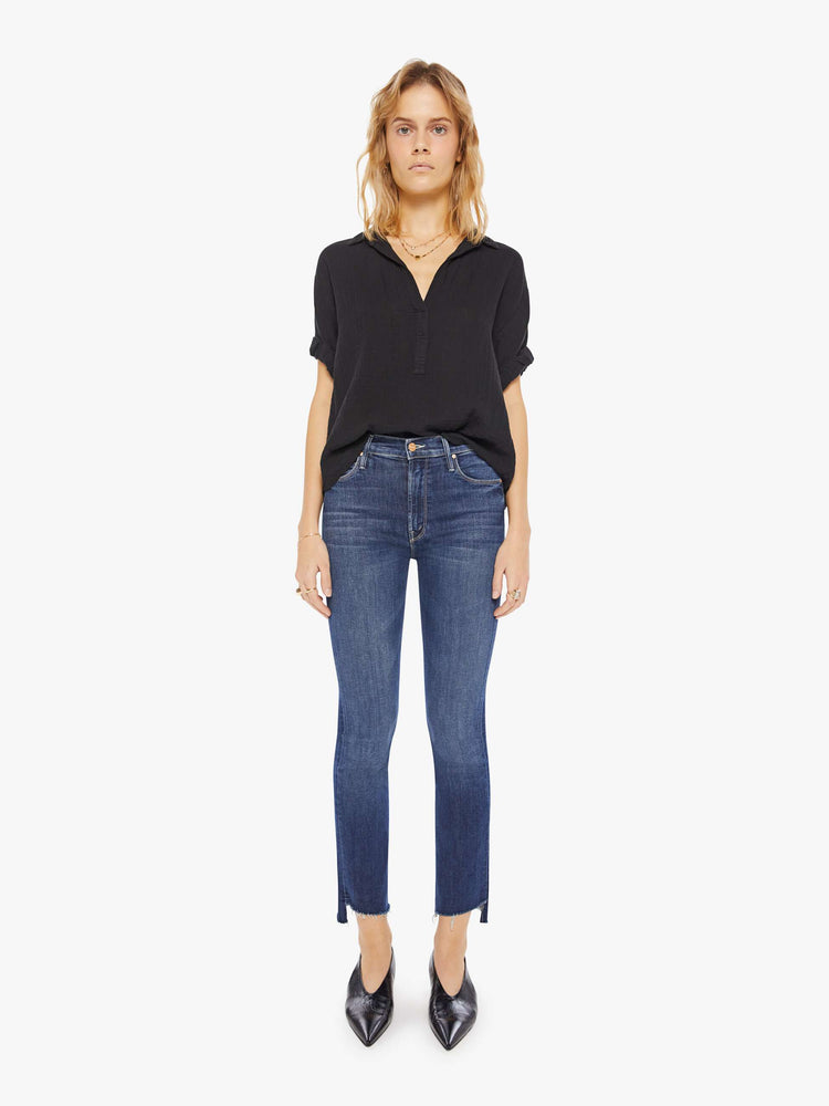 Womens front full body view of a collared, black, V-neck shirt with rolled elbow-length sleeves and a slightly boxy fit.