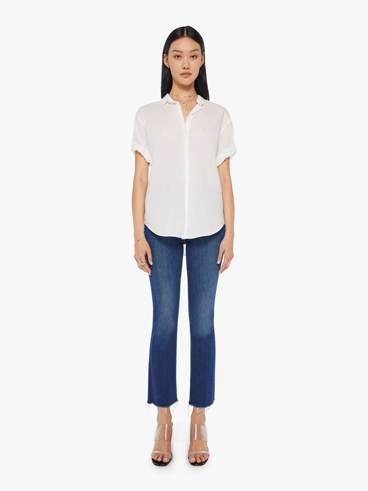Front full body view of a woman wearing a white short sleeve button up shirt