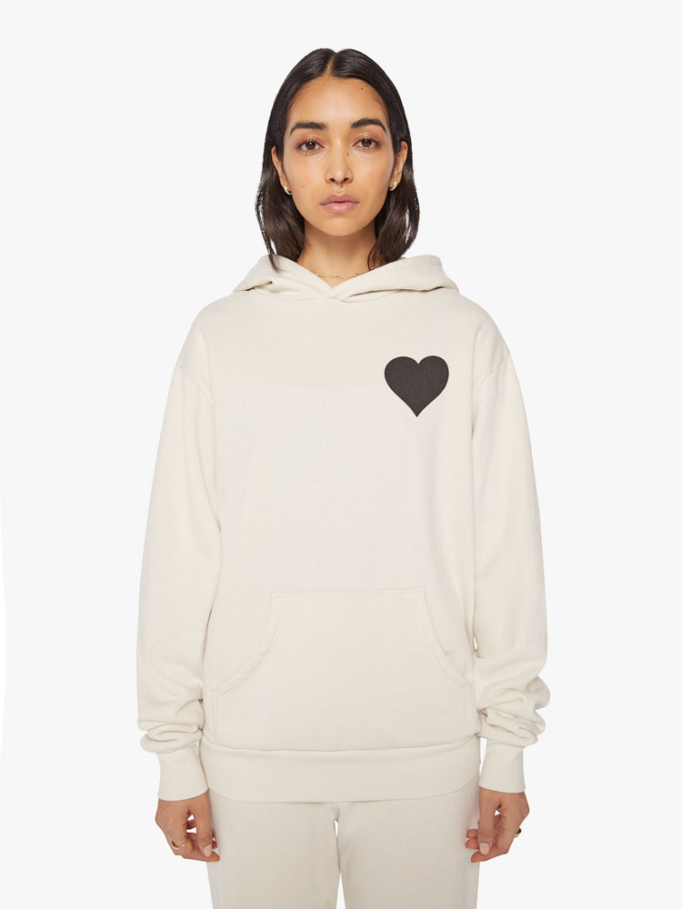 Front view of a Womens white hoodie pullover with a front kangaroo pocket and a black heart graphic printed on the chest.