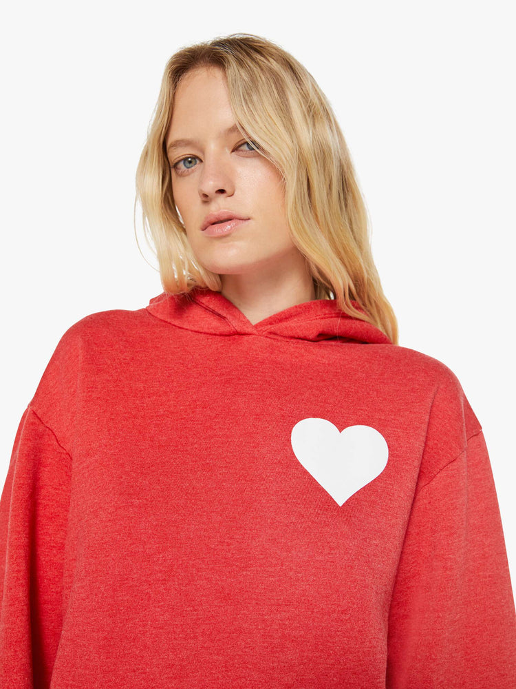 Close up view of a woman in red sweatshirt has a front patch pocket and a loose, comfortable fit.