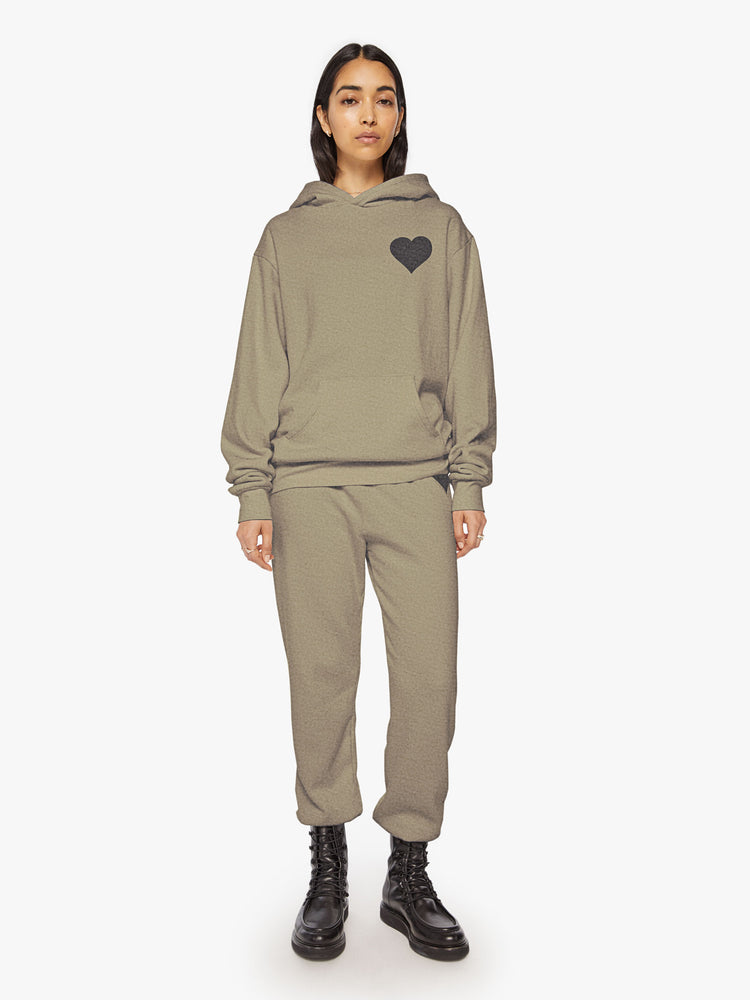 Full body view of a woman army green sweatshirt has a front patch pocket and a loose, comfortable fit.