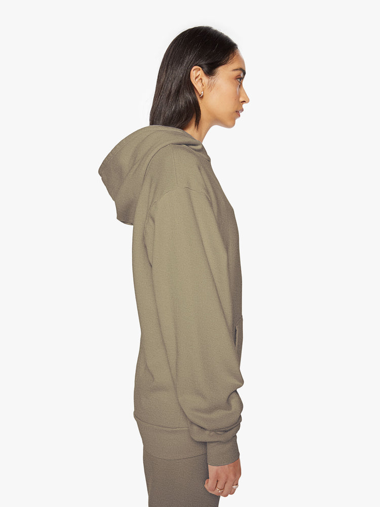 Side view of a woman army green sweatshirt has a front patch pocket and a loose, comfortable fit.