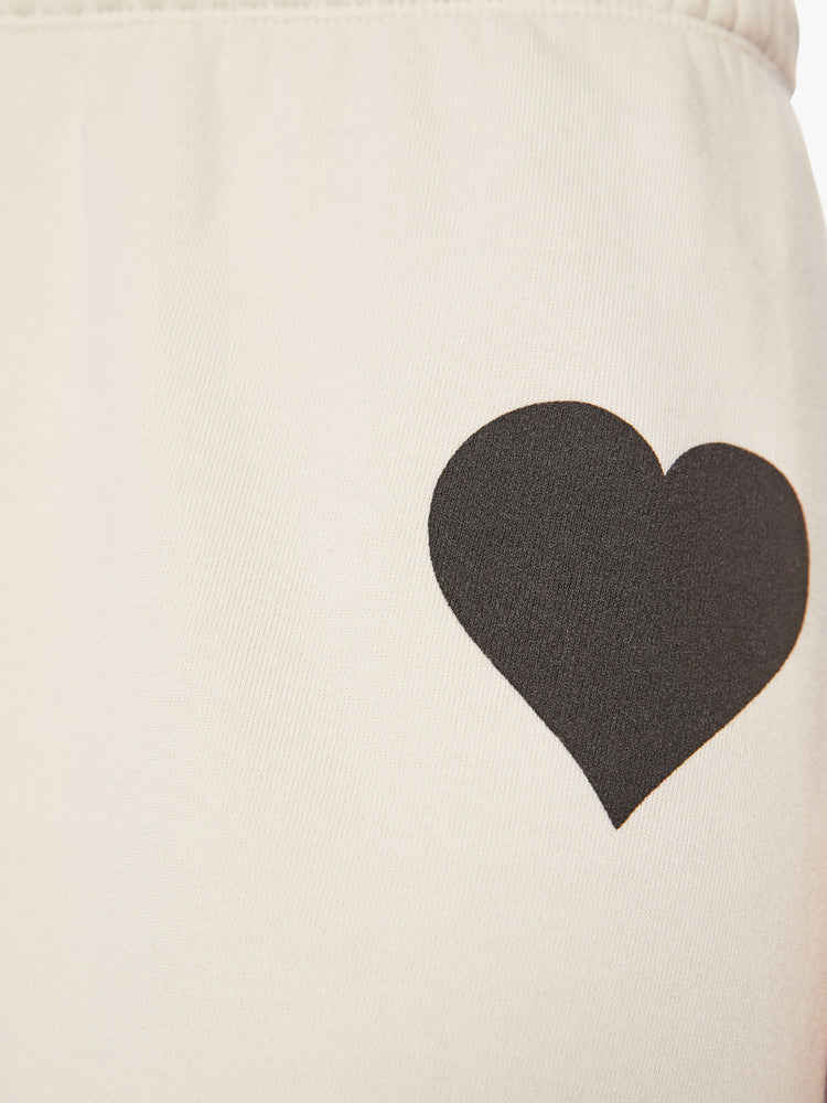 Swatch close up view of a Womens white sweatpant with a black heart graphic printed on the left side hip.