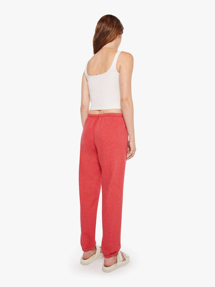 Back view of a woman in red sweatpants have an elastic waist and cuffs for a loose, comfortable fit.