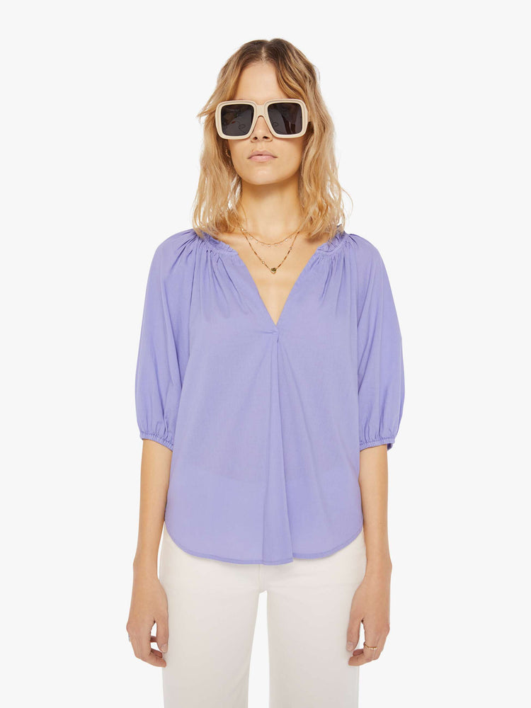 Front view of a womens light purple blouse featuring a v neck, elastic 3/4 length sleeves, and a flowy fit.