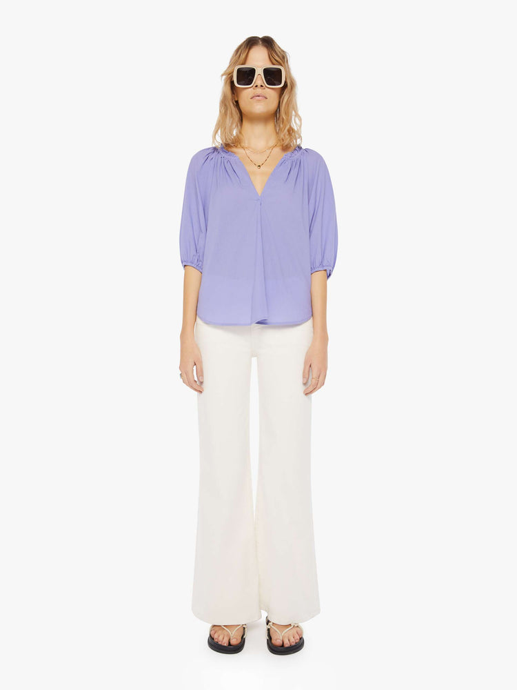 Front full body view of a womens light purple blouse featuring a v neck, elastic 3/4 length sleeves, and a flowy fit.