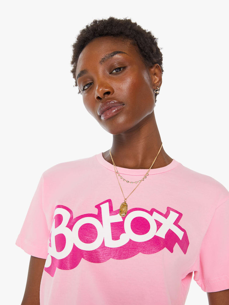 Detail view of a women's light pink t-shirt with a hot pink "Botox" graphic