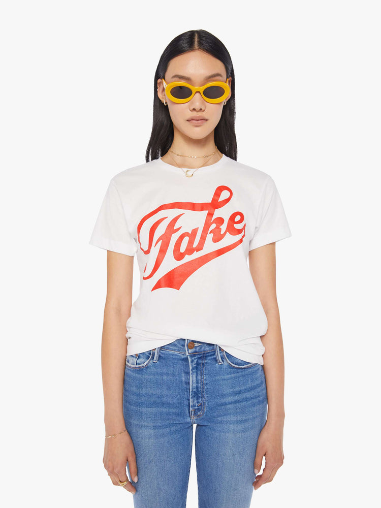 Front view of a women's white t-shirt with red "Fake" graphic
