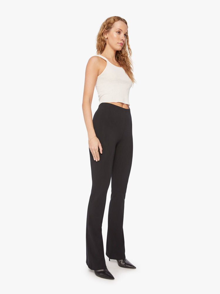 Front full body view of a womens black high rise pant featuring a fitted flare leg.