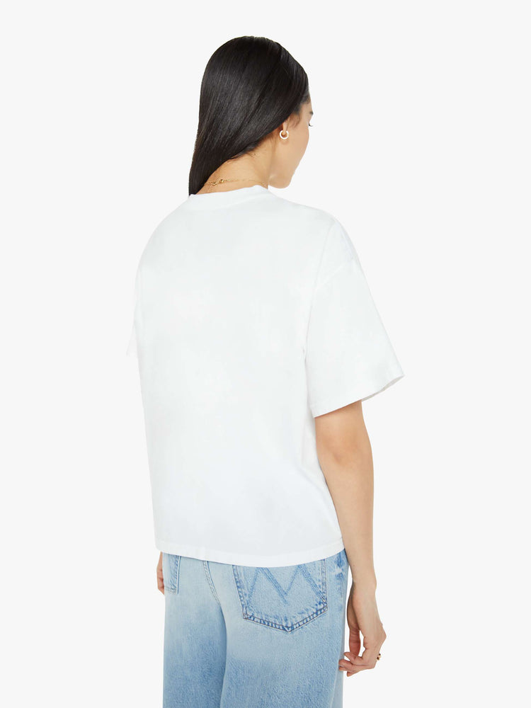 A back view of a woman wearing a white oversized tee