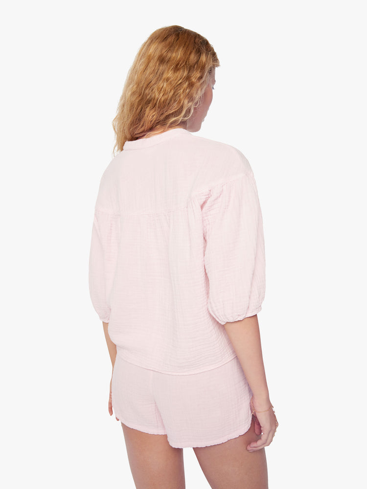 Back view of a woman baby pink top designed with a V-neck, 3/4-length balloon sleeves.