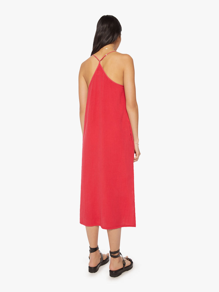 Back view of a woman red midi dress designed with a gathered scoop neck, spaghetti straps and a racerback.