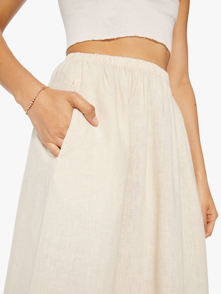 Close up view of a woman maxi skirt features a high rise, elastic waistband, and a loose, flowy fit.