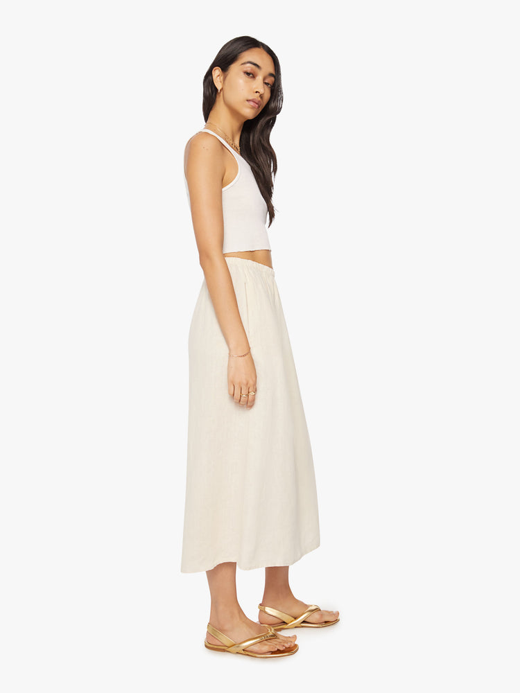 Side view of a woman maxi skirt features a high rise, elastic waistband, and a loose, flowy fit.