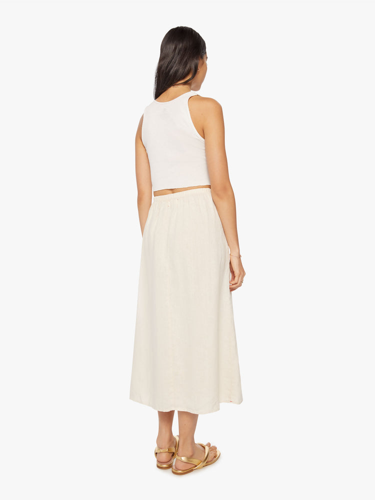 Back view of a woman maxi skirt features a high rise, elastic waistband, and a loose, flowy fit.