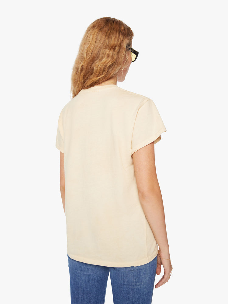 WOMEN Back view of a woman tea-stained white hue with small tears throughout, the tee offers a sign of peace with a green weed leaf graphic on the front.