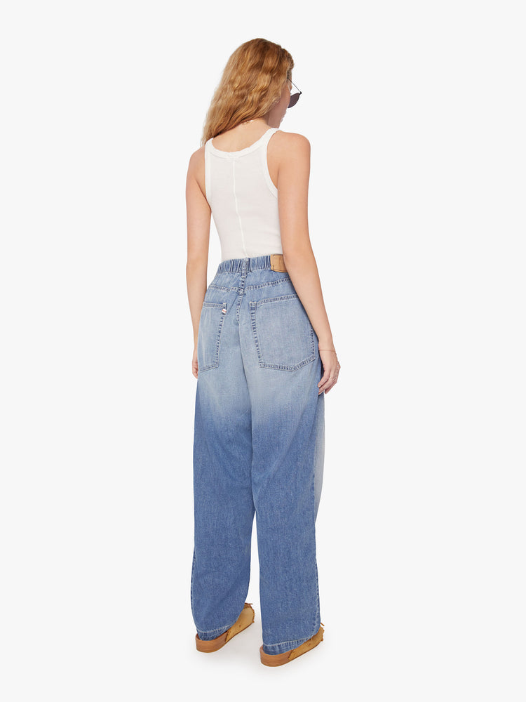 WOMEN back view of a wide-leg denim pants in a mid-blue wash with fading at the knee.