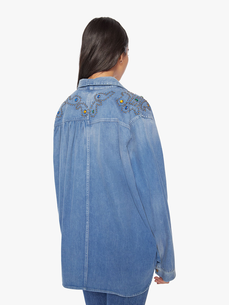 Back  view of a woman long-sleeve button-up is designed with front patch pockets, gathered shoulder seams and a slightly oversized fit.