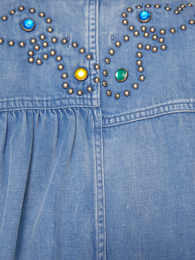 Close up view of studded details on back of long sleeve button up shirt.