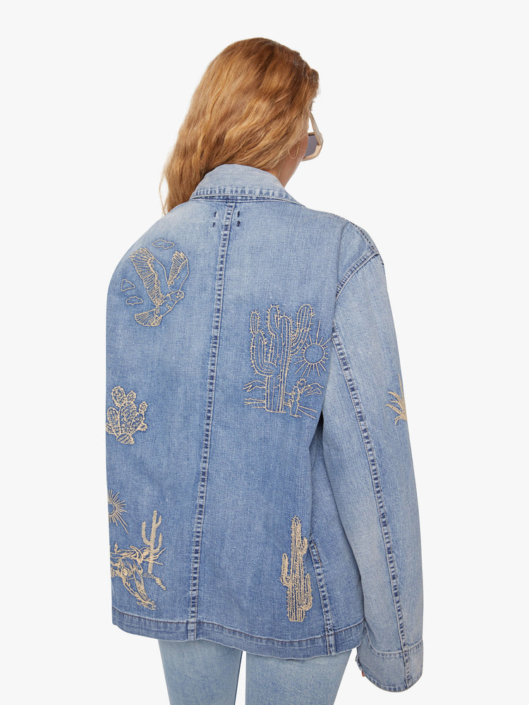 WOMEN back view of a jacket in a mid-blue wash with fading and embroidered details inspired by the landscape of Joshua Tree.