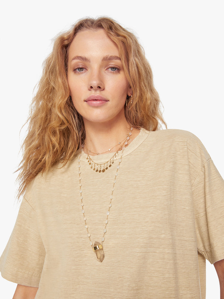 Close up view of a woman in a Model Crop T features drop shoulders, a boxy fit and a slightly cropped hem in a soft khaki hue.