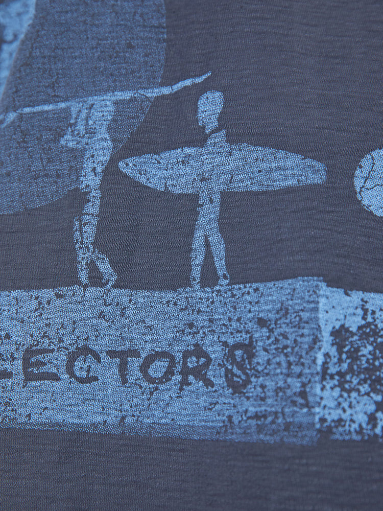 Close up view of a woman in black tee with a blue surfer graphic, and features drop shoulders and a boxy fit.