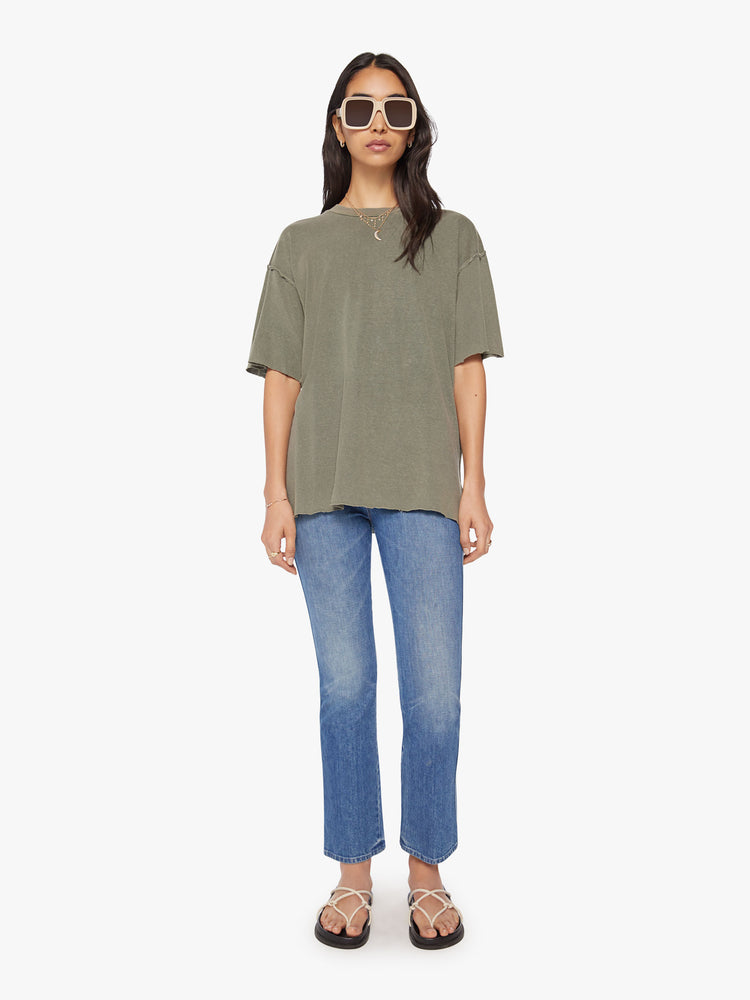 Full body view of a woman in a cropped crewneck tee with drop shoulders, a boxy fit in a sage green hue.