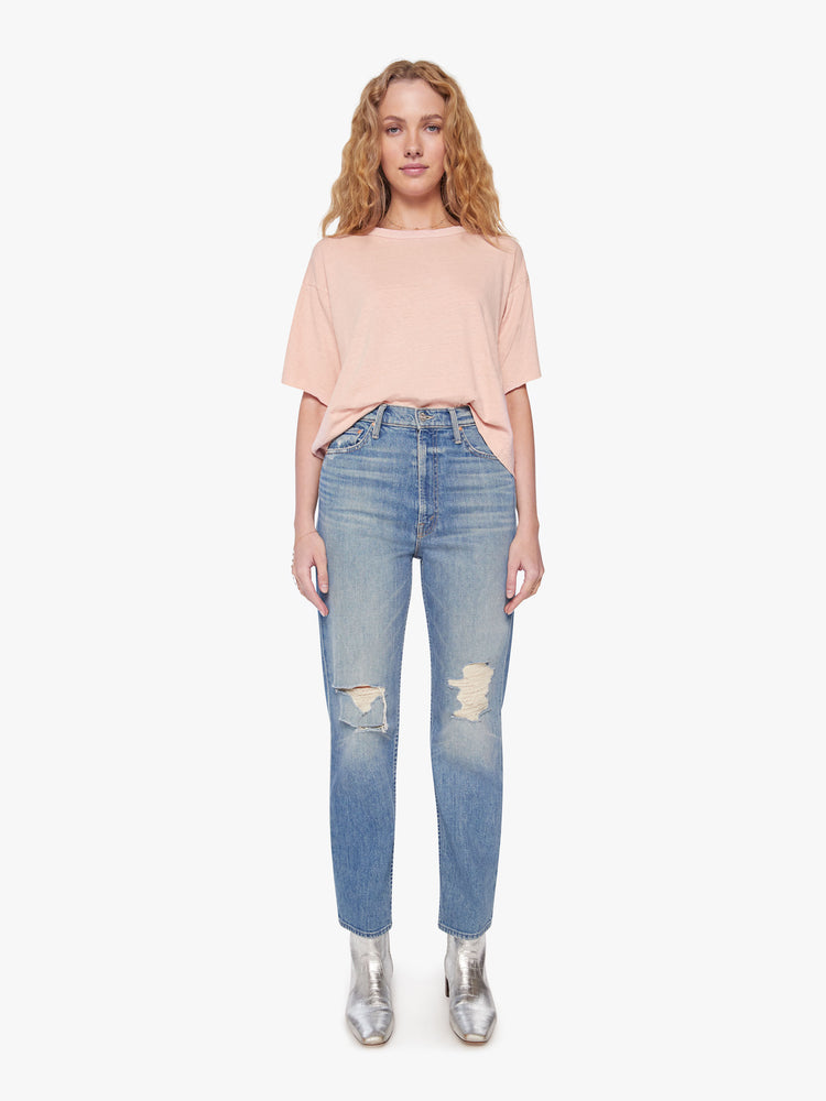 Full body view of a woman crop tee with drop shoulders, a boxy fit in a soft pink hue with fringe across the back.
