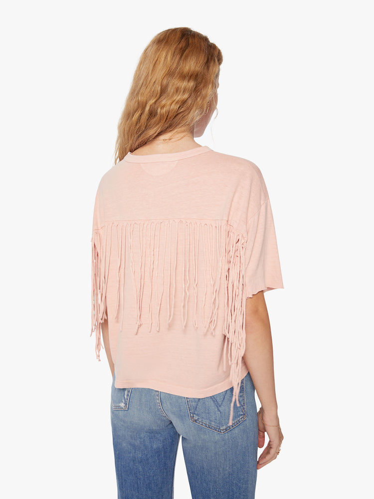 Back view of a woman crop tee with drop shoulders, a boxy fit in a soft pink hue with fringe across the back.