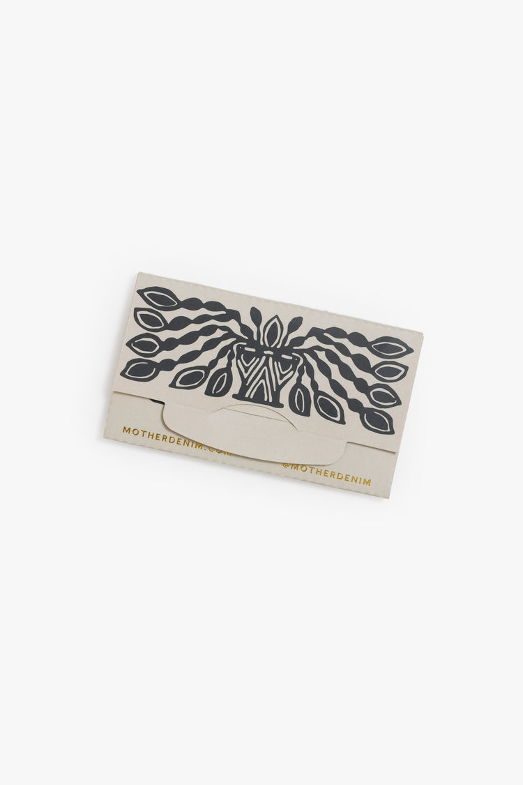 Flat of a pack of rolling papers featuring black and gold graphics.