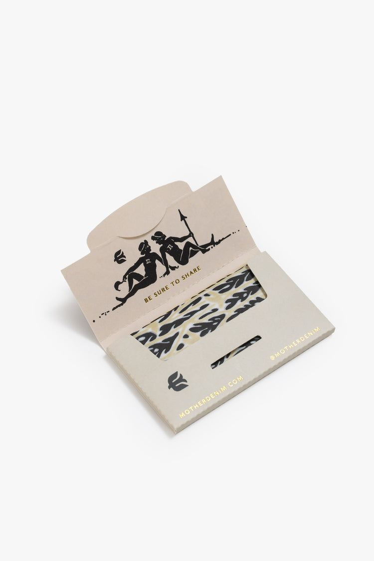 Flat of a pack of rolling papers featuring black and gold graphics.