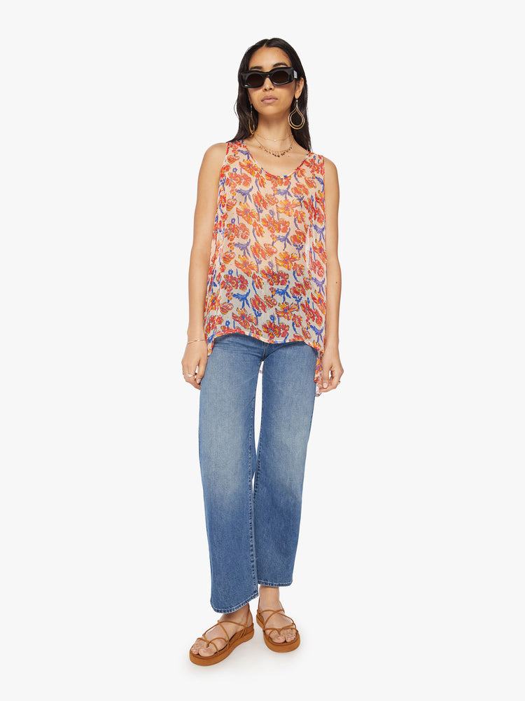 Full body view of a woman tank in off-white chiffon with a watercolor floral print in orange and navy with a hip-grazing hem.