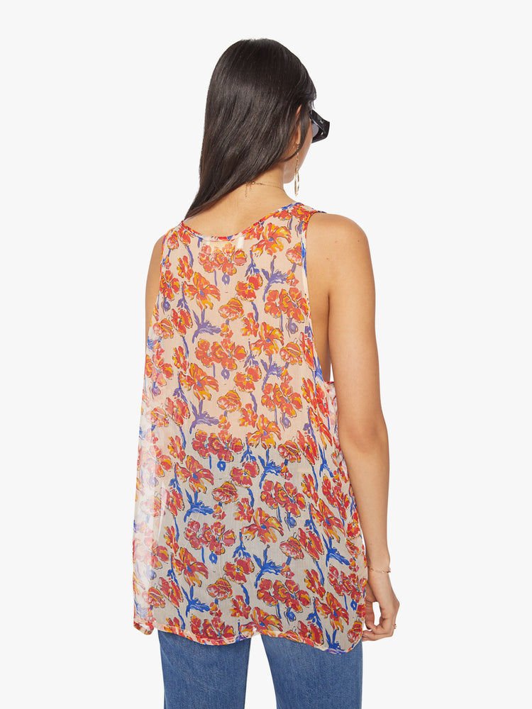 Back view of a woman tank in off-white chiffon with a watercolor floral print in orange and navy with a hip-grazing hem.