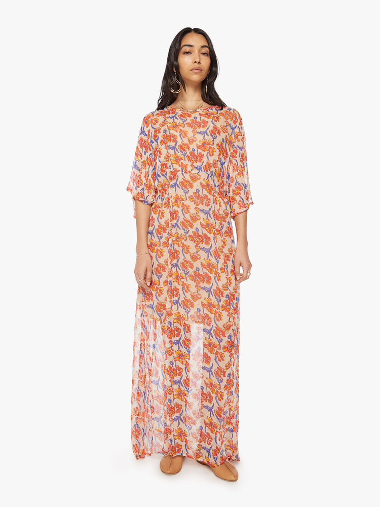 Front view of a woman's maxi dress in an off-white chiffon with a watercolor floral print with a crewneck, elbow-length sleeves, curved waist and ankle length hem.