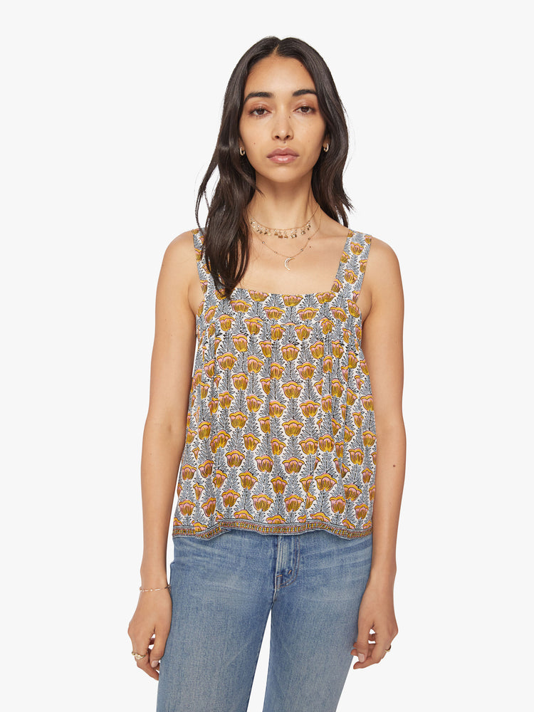 Front view of woman's top in a blue and yellow tulip print, and detailed straps and buttons in the back.