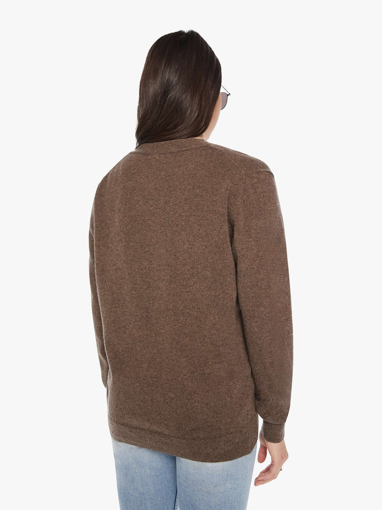 Back view of a woman cardigan in an earthy brown hue with V-neck, patch pockets and buttons down the front.